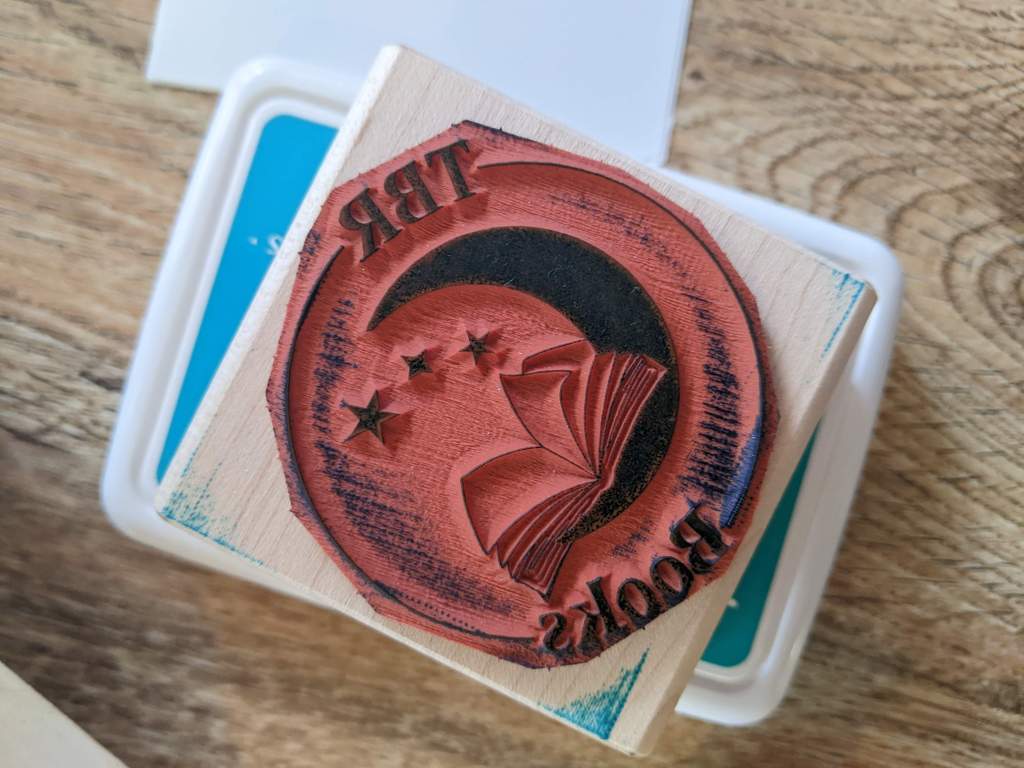 Rubber stamp with TBR Books logo on it