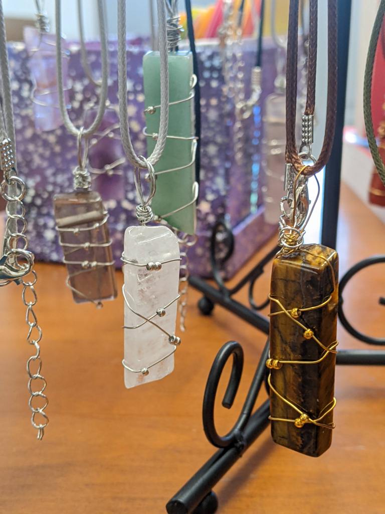 A variety of wire-wrapped pendants dangling on necklaces